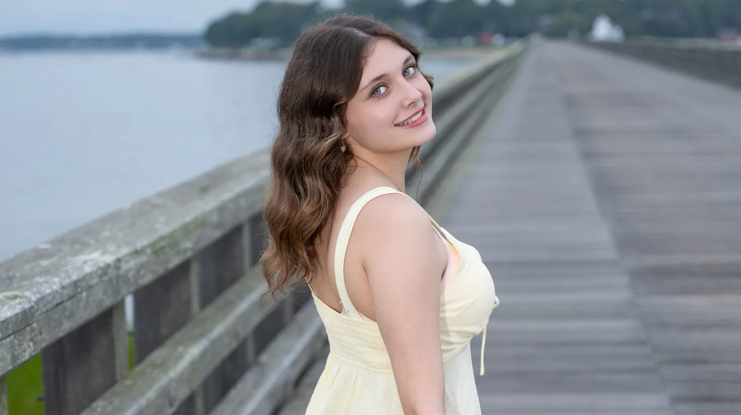 High school senior photographed on the weathered timber walkway of the Powder Point Bridge, Duxbury Beach MA